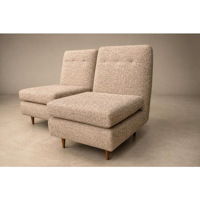Designed by Joaquim Tenreiro (1906–1992), this exceptional pair of “L” lounge chairs, conceived in 1958, exemplifies the...