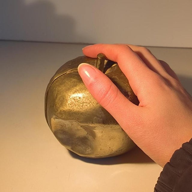 A surrealist and pop art sculpture created by a. Pisani in 1974 , depicting a partially bitten apple from which two shapes...