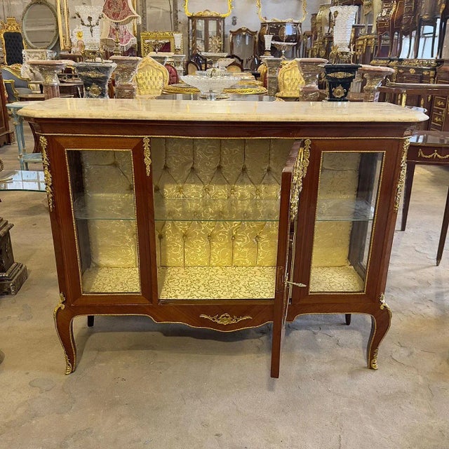 In love with the details. Stunning french vitrine. Has a beautiful gold details and it has a yellow internal upholstery...