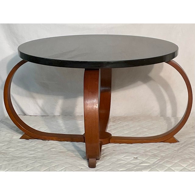 Elevate your living space with this stunning Art Deco coffee table. The elegant design features a sleek, round black...