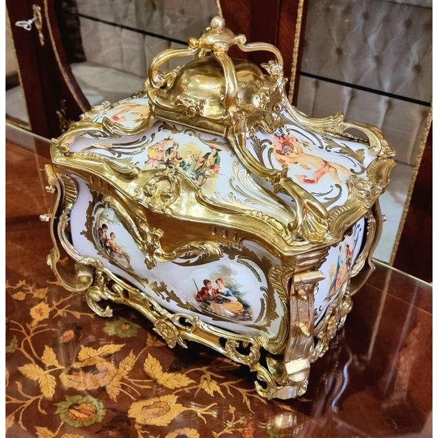 Exquisite French Rococo style jewelry box featuring elegant gilt bronze ormolu mounts and beautifully hand-painted...