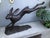 A wonderfully dynamic large-scale bronze sculpture of a hare captured at full speed, its elongated body suspended...