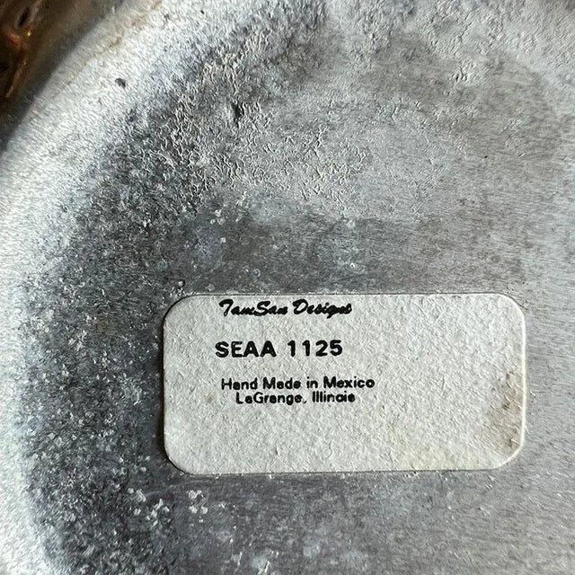 A silver metal Hollywood Regency serving bowl with a sea shell motif around the edges. This piece was made in Mexico and...