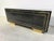 Luxurious sideboard made from shiny black lacquer and brass hardware. This high end sideboard is very much in the style of...