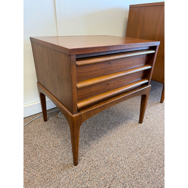 Offering a 1963 walnut nightstand by Lane Furniture Company from their Rhythm line. Beautiful simple lines are why this...