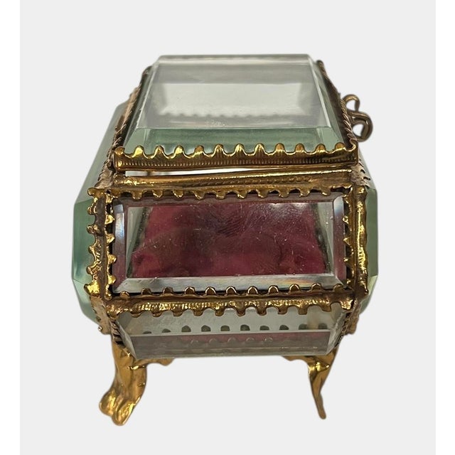Stunning Victorian era gilt metal jewelry or trinket casket. Ormolu metal set upon 4 feet with beveled glass panels....