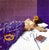A figure lies face down across a dense purple bed, a golden crown resting at the feet and a small orange flower placed...