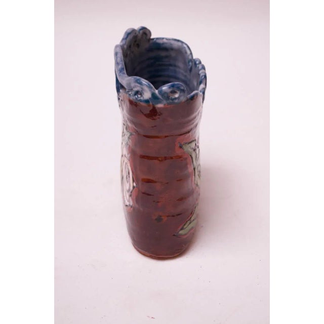 Studio terracotta vase with dual-sided floral motif in a high-gloss glaze of red, blue, white green, and yellow (Mid-20th...