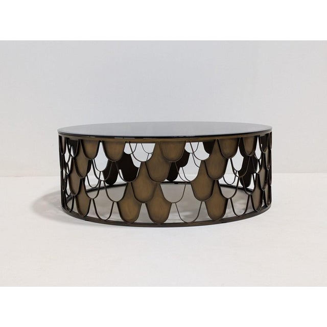 The lovely L’indiscret Coffee Table features an antique copper finish and a tawny glass tabletop. Its design is inspired...