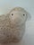 A charming English Staffordshire-style reproduction sculpture depicting a recumbent lamb. The lamb has a sweet, expressive...