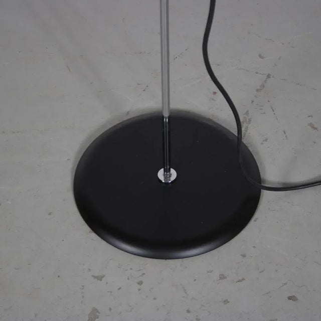 A 1980s black metal minimalist floor lamp designed by Joe Colombo for Oluce, Italy. This striking floor lamp embodies the...