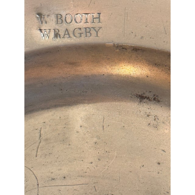 A large pewter charger engraved "W. Booth of Wragby" with maker's touchmarks on the reverse. Good weight and color.