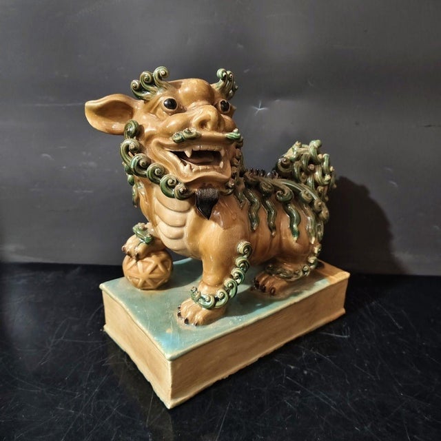 Bring traditional Asian mystique and protective energy to your home with this handsome pair of vintage Shiwan Kiln ceramic...