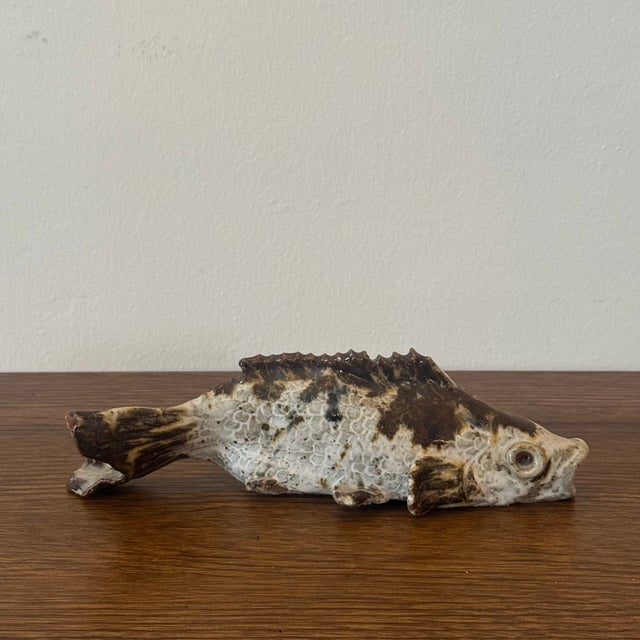 A vintage American folk art pottery fish sculpture featuring a hand-sculpted form with textured glaze and naturalistic...