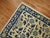 An early 20th century Chinese peking throw rug. Cream field with blue accents. 3' x 5'10''