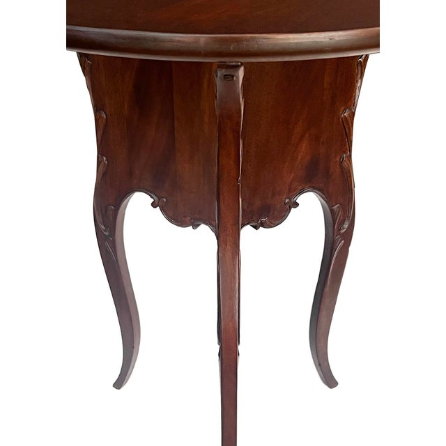 featuring a round dish-top above a shapely tripod base with scalloped apron and adorned with foliate scrolls all raised on...