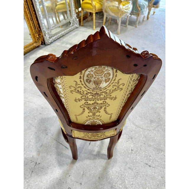 Add timeless elegance to your home with this French Rococo-style vintage chair. Featuring a hand-carved wooden frame, it...