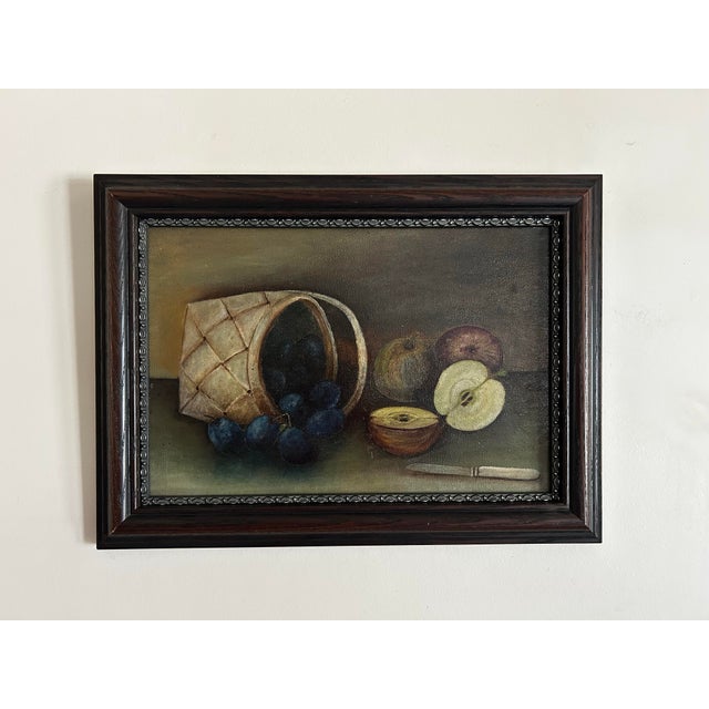 Antique oil painting, still life of apples and plums in basket. Signed en verso, Annie Dewey. In wood frame.
