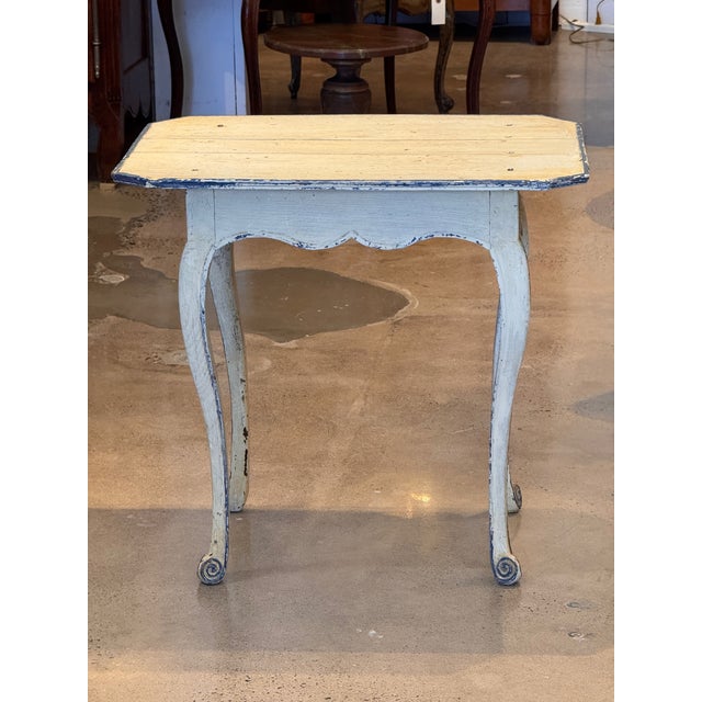 A 19th century painted Swedish table with a rectangular plank top with clipped corners, raised on four shaped legs with...