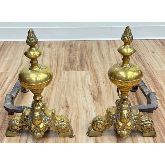 Antique French Baroque style brass andirons-chenets. Each features decorative maiden cast onto an ornate, scrolling...