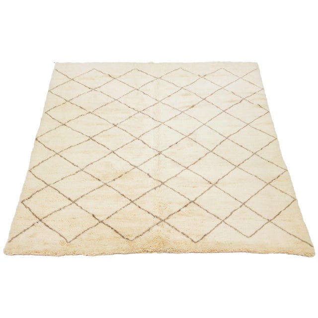 A stunning contemporary Moroccan-style wool rug, meticulously hand-knotted with a beige base and complemented by brown...