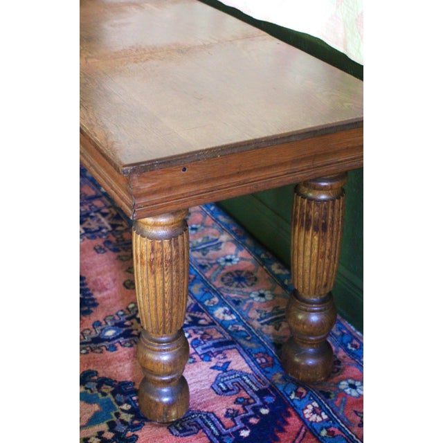An antique dining table that has been converted to a low console table. Gorgeous thick fluted legs and beautiful antique...