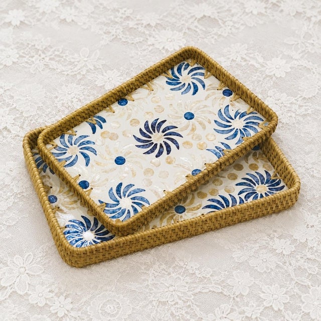 This set of two rectangular decorative trays is handmade by Vietnamese craftsmen. The frame is woven from natural rattan...