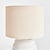 A ceramic base, this little lamp has a speckled, reactive glaze that plays off the carved meandering pattern. Topped with...