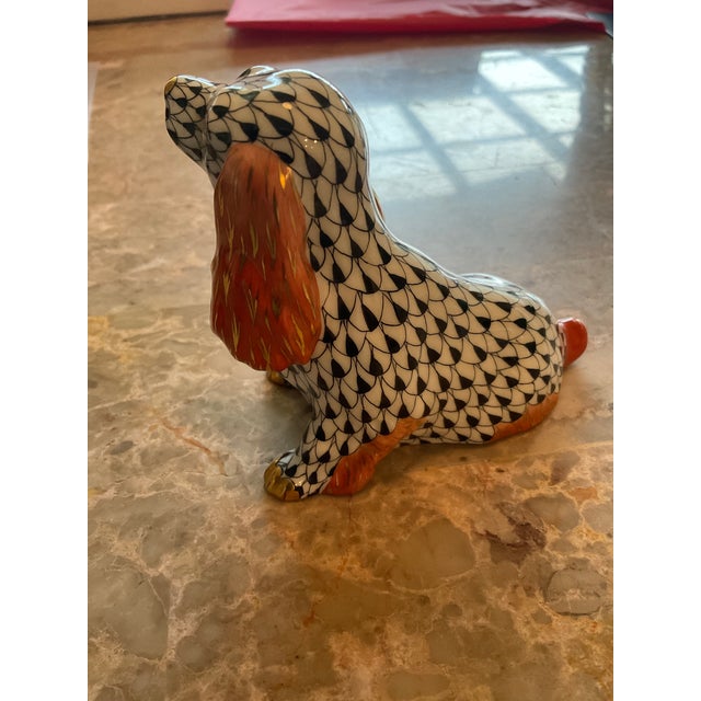 Adorable Herend Black Fishnet Sitting Spaniel. Measuring 5” from tail to nose by 2” wide by 3.5” high It has 24K gold...