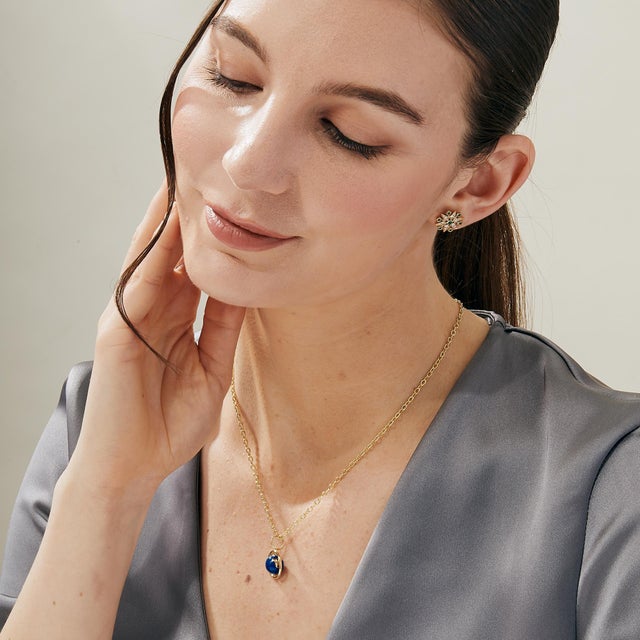 Created in 18 karat yellow gold Lapis enamel details Chain sold separately Crafted from 18 karat yellow gold, this...