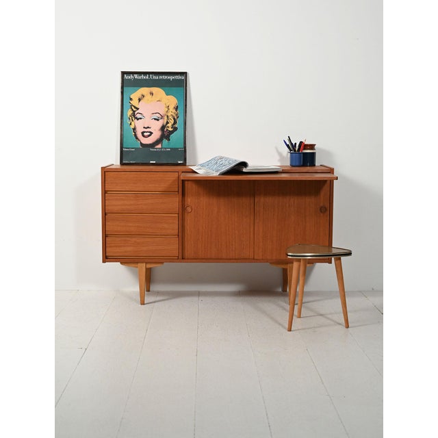 Small teak sideboard by Karlit Karlhom, with tin drawers, hinged doors, a pull-out writing desk, and the original stamp....
