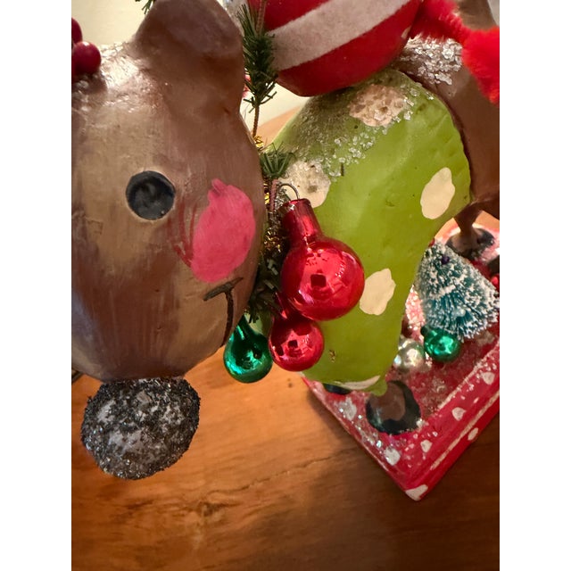 Pure Fun! Bobble Head Santa with greenery reins, riding a reindeer with a green sweater and white polka dots and twigs...