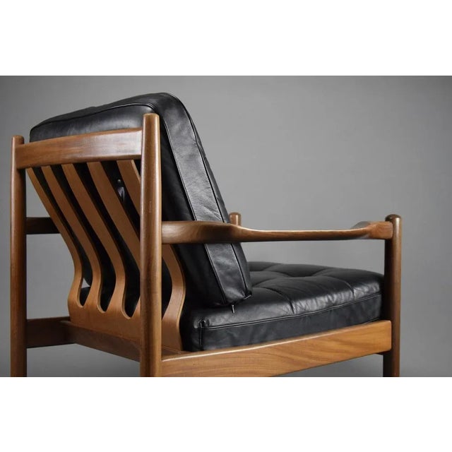 Introducing the Epitome of Mid-Century Elegance: The Jatoba Wooden Lounge Chair Experience timeless luxury in your living...