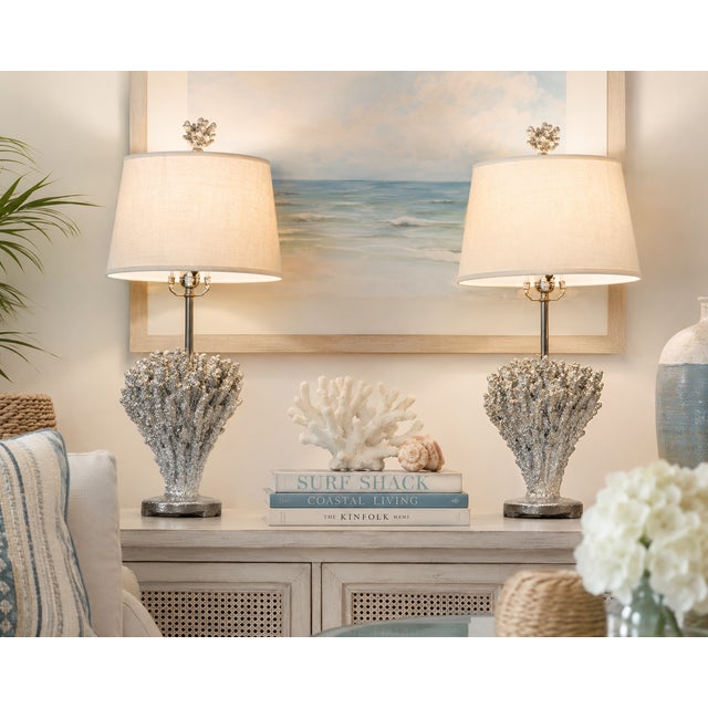 A striking pair of sculptural table lamps featuring dramatic coral-form bases finished in textured silver. Their highly...