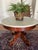 An elegant antique mahogany center table with marble top is offered for sale. The mahogany base has lovely lines and...