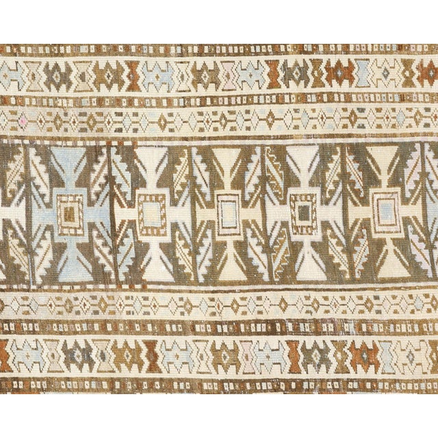 This distinguished runner originates from the Melayer weaving tradition of Iran's Hamadan region, showcasing the refined...