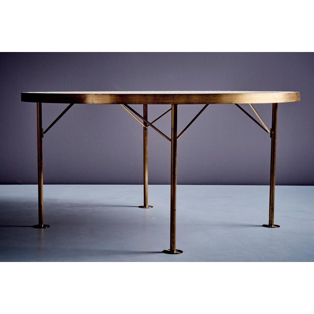 Round mosaic top coffee table with a brass rim around it on four legs, by Berthold Müller. The top has an abstract...