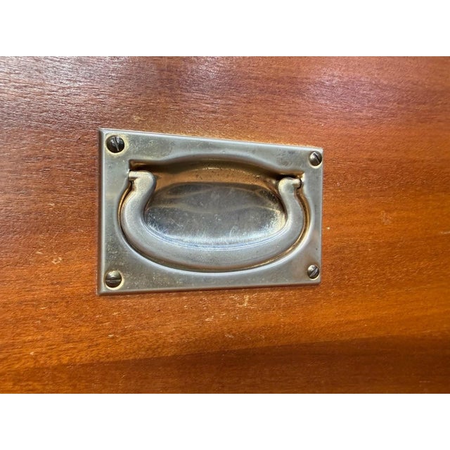 A distinctive piece with maritime origins, directly inspired by British military furniture. This magnificent nautical...
