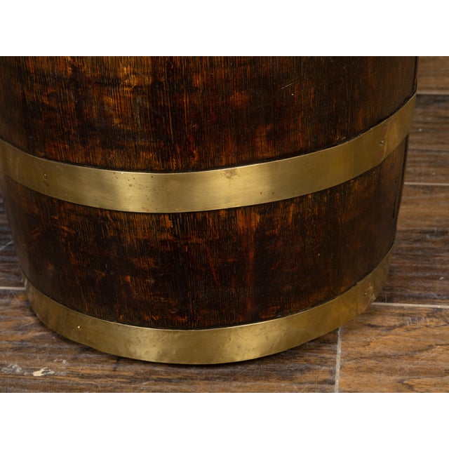 A rustic English turn of the century oak barrel from the early 20th century, with brass braces and tin interior. Created...