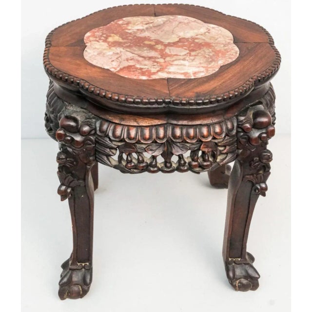 With carved foo dog elements and inset rouge marble top. Excelent occasional table or for a plant. Measures 17 1/2" x 17...