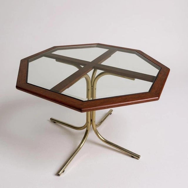 Striking vintage octagonal dining table in the Hollywood Regency style, featuring a brass pedestal base with elegant...