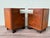 Pair of 1930s bedside tables featuring a top drawer, an open side compartment, a main door, and solid, molded, and shaped...