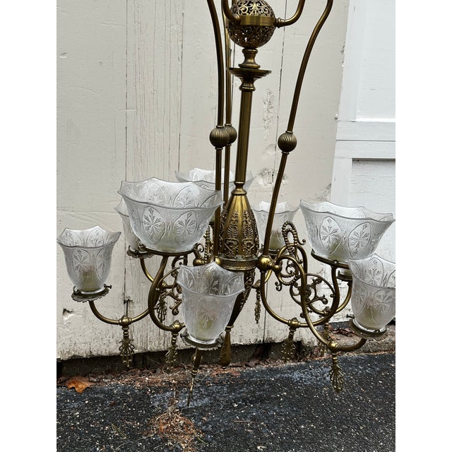 Old Lights On is pleased to offer a nine light restored gas brass fixture with vintage shades. Rewired and ready to...