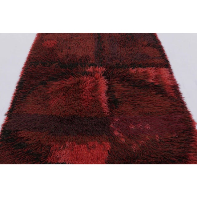 Hand-knotted in lush, high-pile wool in Sweden circa 1960-1970, this 5x7 vintage Swedish Rya rug is a bold new addition to...