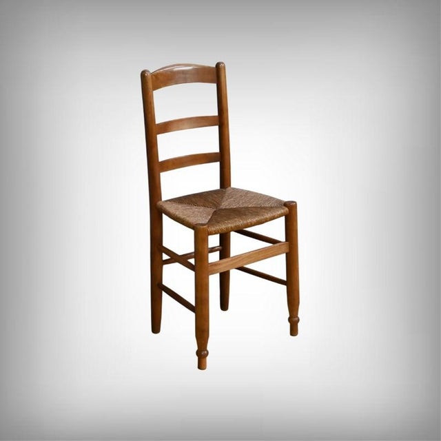 These traditional cherrywood chairs, crafted in the late 19th century, captivate with the warmth of their patina and the...