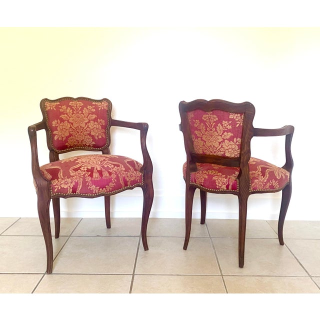 Striking pair of Mid 20th Century Louis XV style upholstered crest back wooden armchairs in the original cotton-linen...