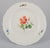 Meissen, Germany A set of four porcelain dinner plates. Hand-painted with different floral motifs. Approximately from...