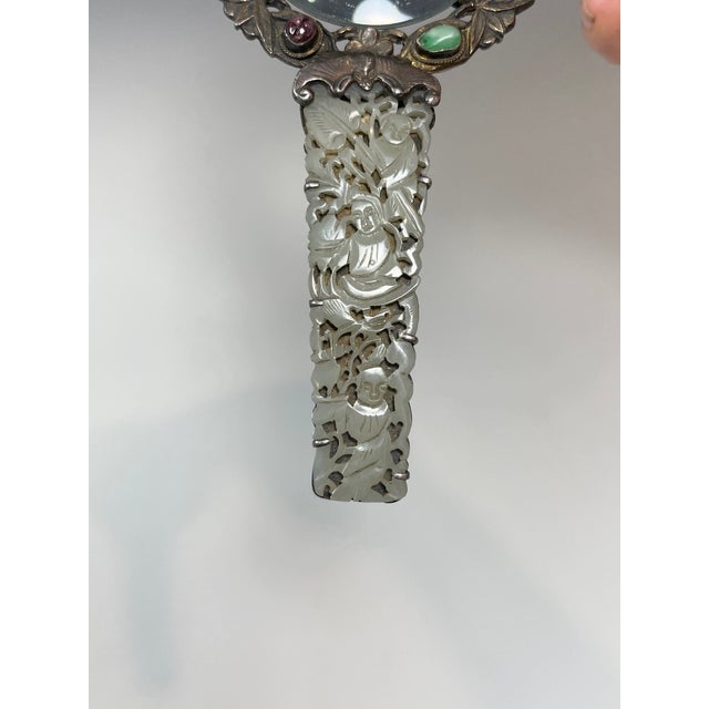 A 19th century Chinese export sliver magnifying glass with open work carved nephrite jade handle. features traditional...