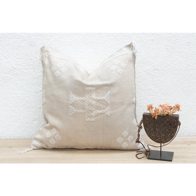 Indulge in the subtle beauty of our handcrafted Moroccan cactus silk pillow, measuring approximately 22 inches square....