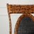 Bamboo and wrapped rattan wrought iron side chair with faux spotted finish. Black woven seat back. Strapped seat supports....